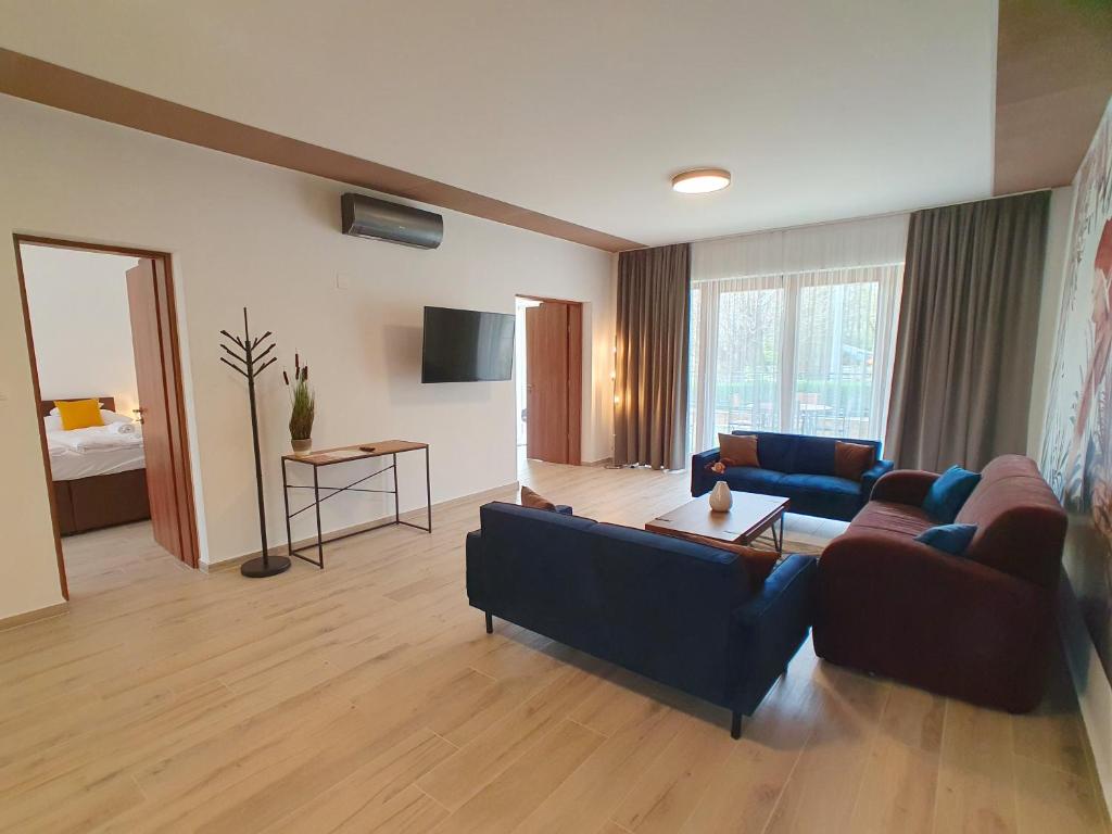 a living room with two couches and a table at Alison Apartments (Nr. 24) in Keszthely