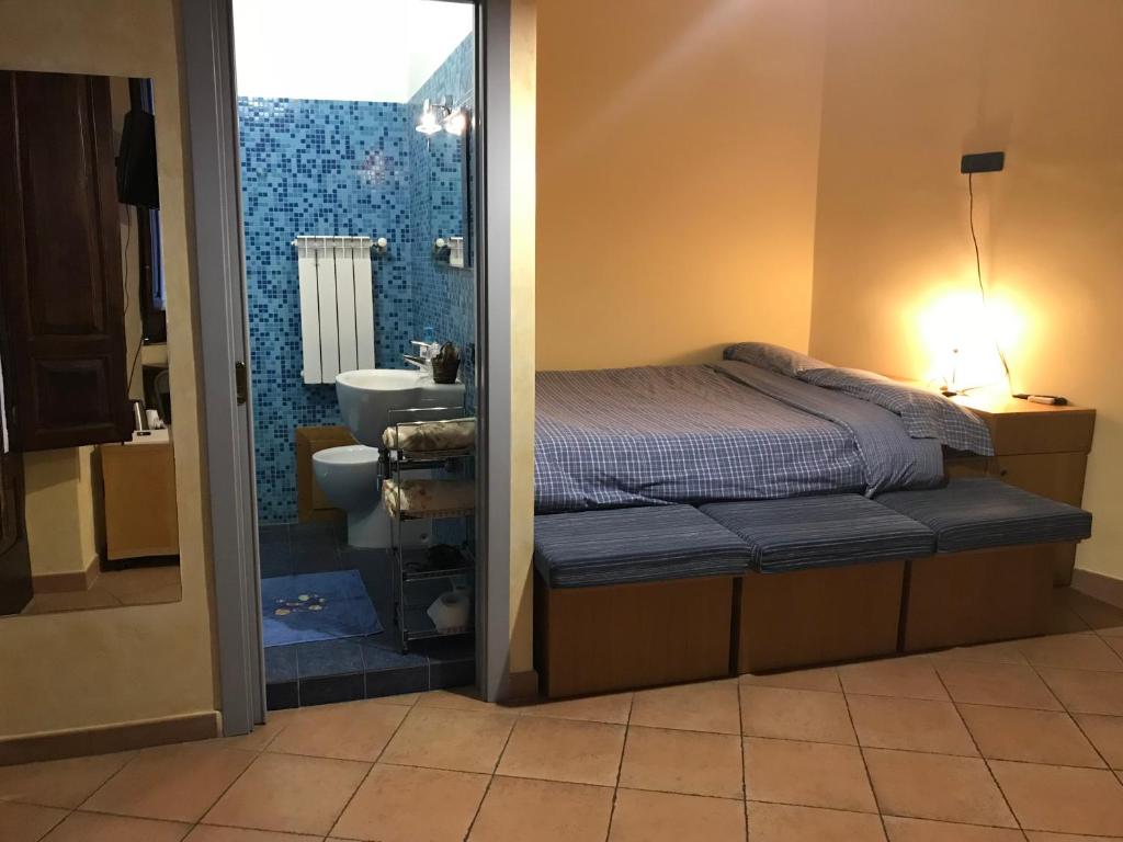 Ένα ή περισσότερα κρεβάτια σε δωμάτιο στο B&B L’Angolo sulla Piazza