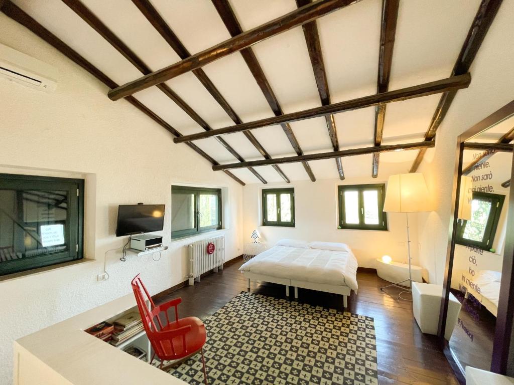 a bedroom with a bed and a table and chairs at La Casa del Poeta Enna - Pergusa in Enna