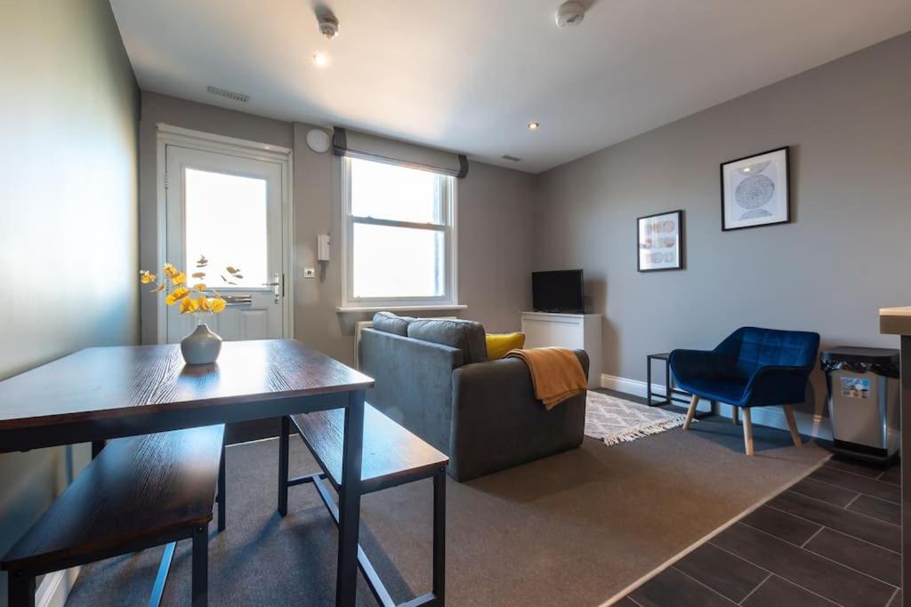 a living room with a couch and a table at Sea Shell - 1 Bedroom Flat in Brighton & Hove