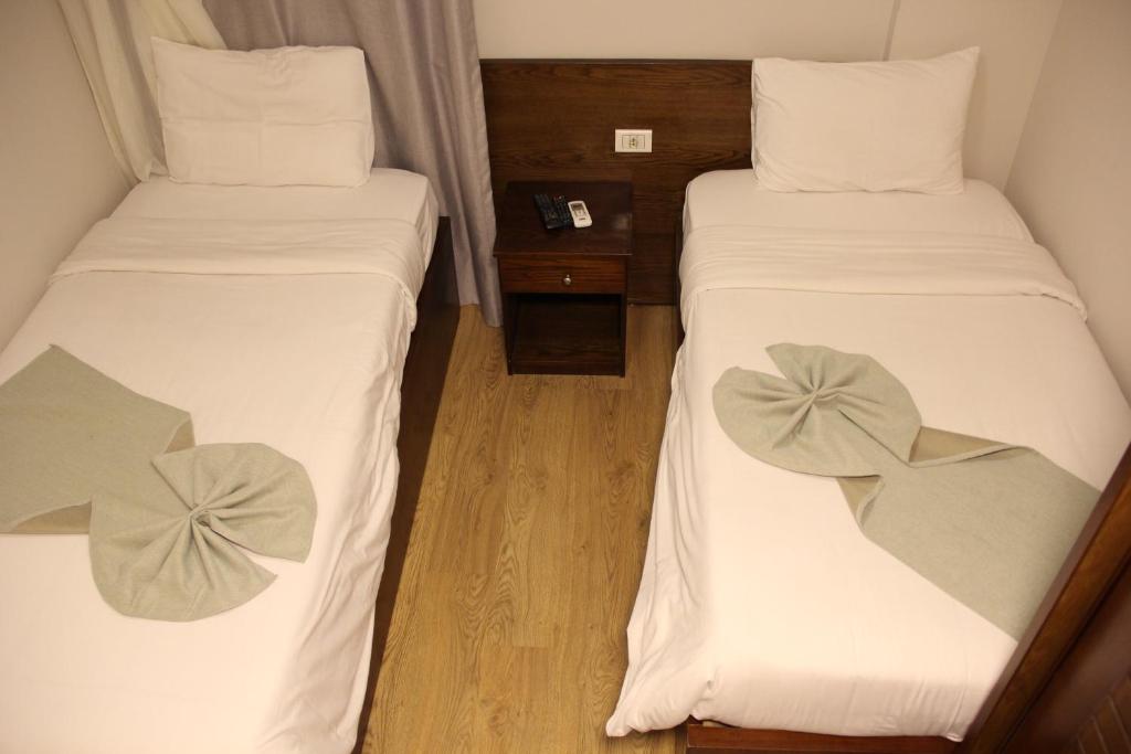 Postel nebo postele na pokoji v ubytování Elysees Hotel Tahrir Square