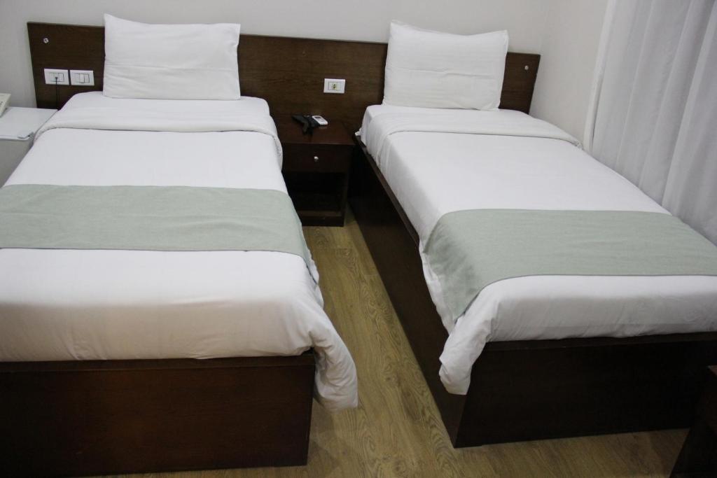 Postel nebo postele na pokoji v ubytování Elysees Hotel Tahrir Square