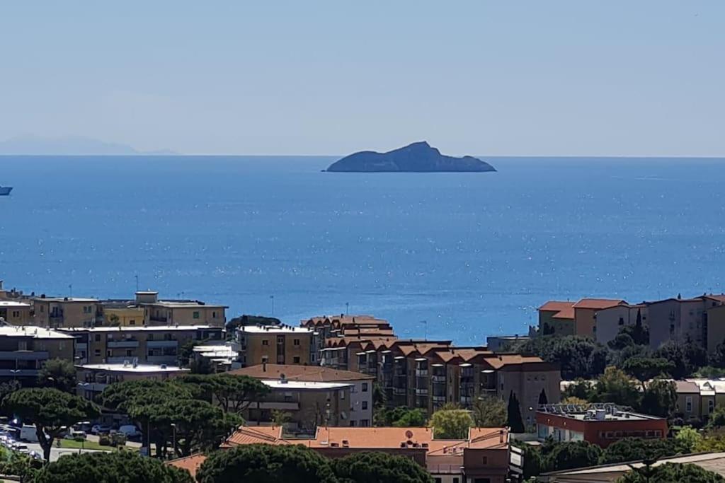a view of a city and an island in the water at Prospettiva Mare Apartament in Piombino