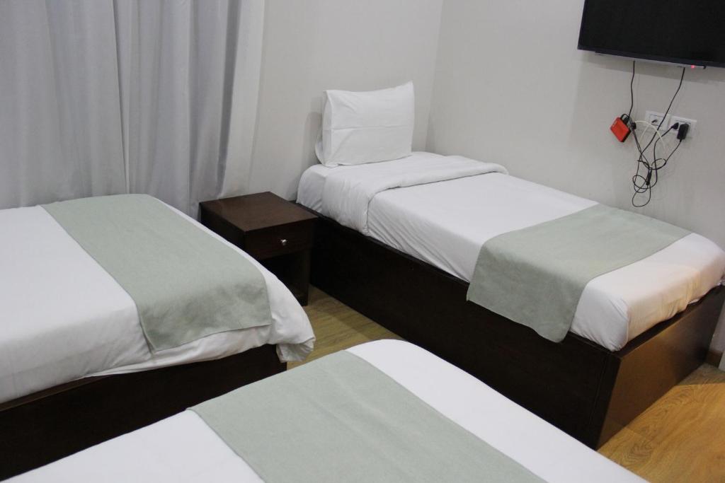 Postel nebo postele na pokoji v ubytování Elysees Hotel Tahrir Square