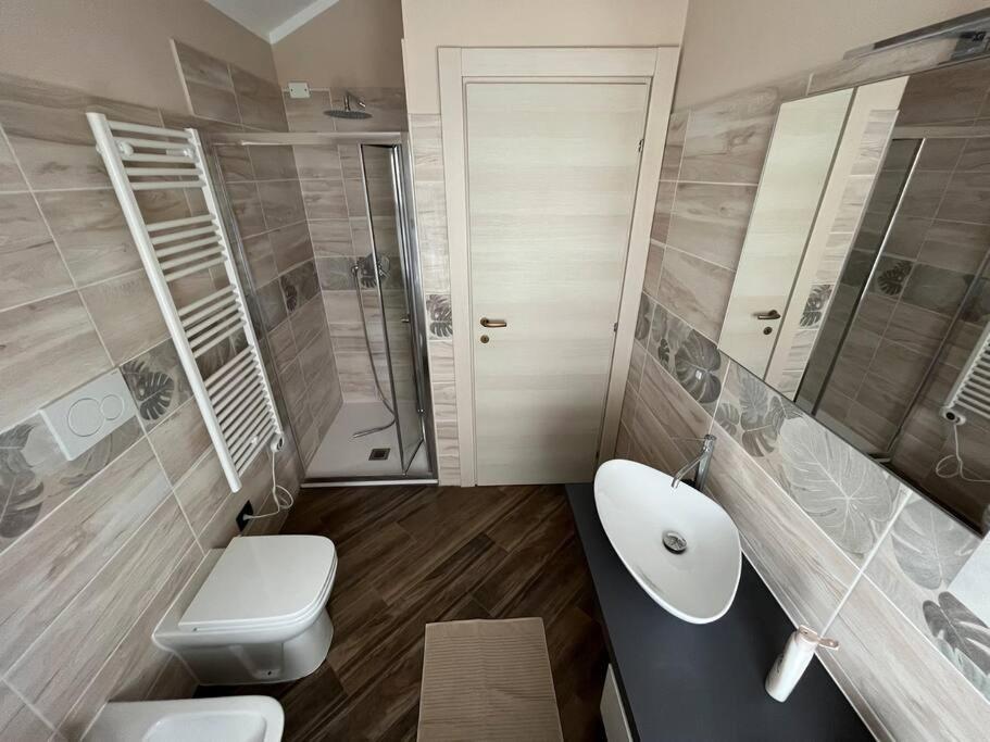 a bathroom with a sink and a toilet and a shower at FONTANA’S HOUSE RELAX 13A in Valbravenna