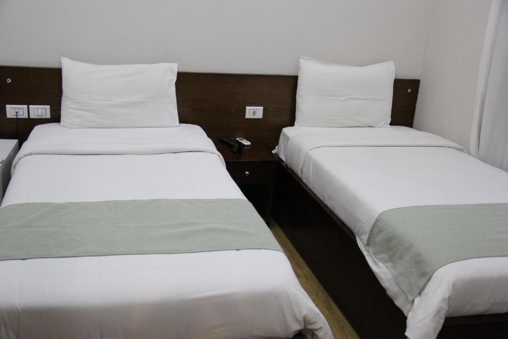 Postel nebo postele na pokoji v ubytování Elysees Hotel Tahrir Square