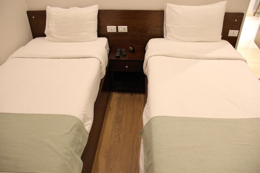 Postel nebo postele na pokoji v ubytování Elysees Hotel Tahrir Square
