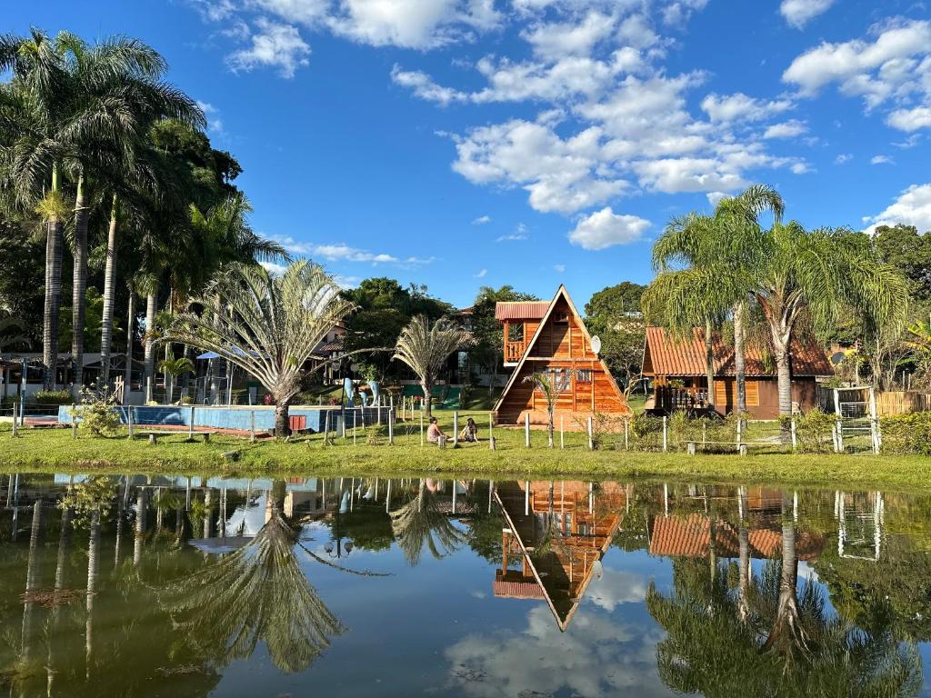 a reflection of a house in a pond at Pousada dos Azevedo in Cláudio