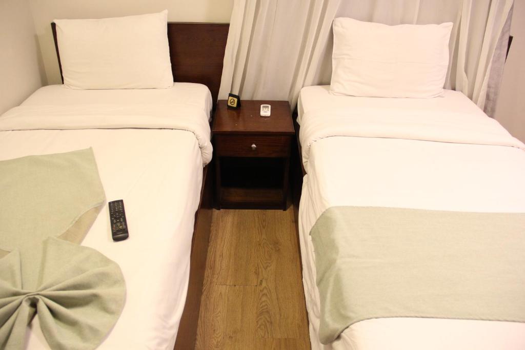 Postel nebo postele na pokoji v ubytování Elysees Hotel Tahrir Square