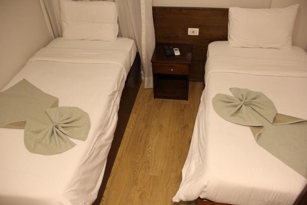 Postel nebo postele na pokoji v ubytování Elysees Hotel Tahrir Square