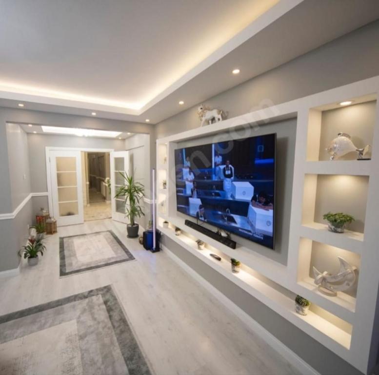a large living room with a large flat screen tv at MAX 3+1 in Istanbul