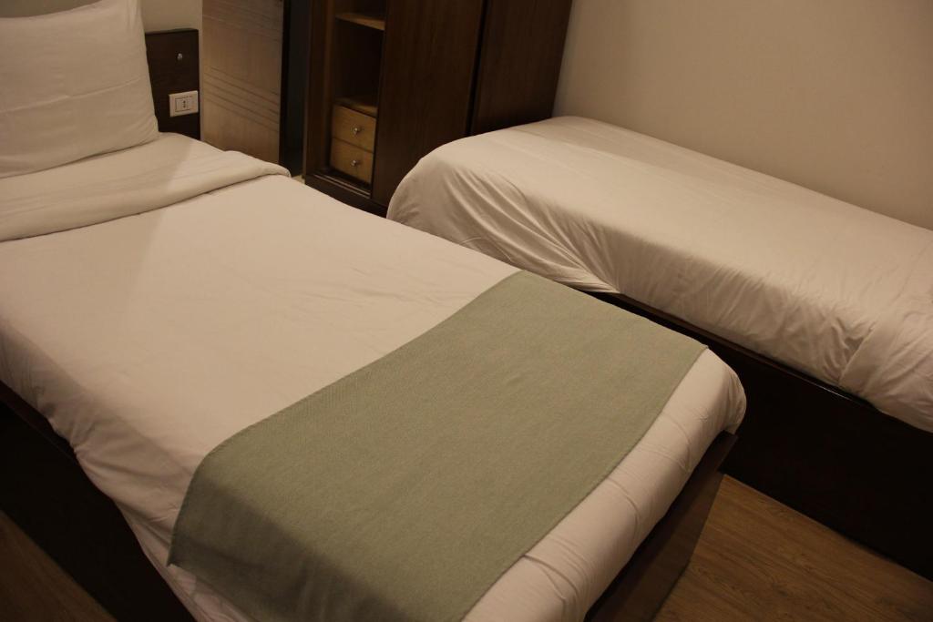 Postel nebo postele na pokoji v ubytování Elysees Hotel Tahrir Square