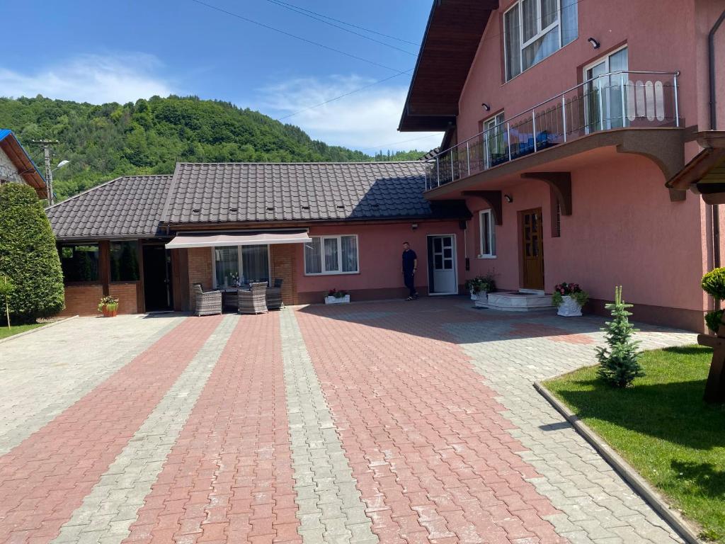 uma casa com uma entrada de tijolos em frente em Vila Mery em Moisei