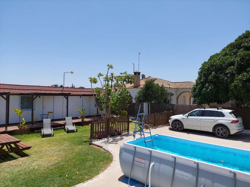 a car parked in a yard with a swimming pool at Single Fin Conil in Conil de la Frontera