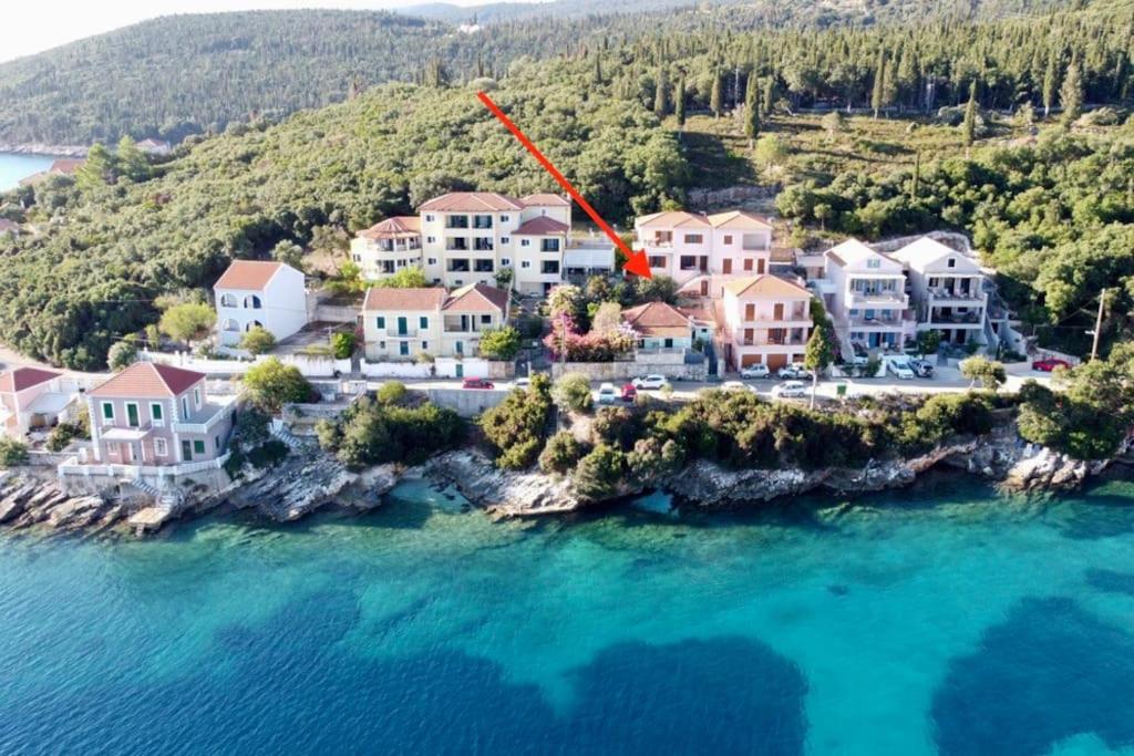 an aerial view of a house on a island in the water at Tassos Cottage Fiskardo in Fiskardho