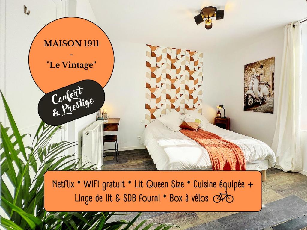 a bedroom with a bed with a orange sign at Studio LE VINTAGE - Maison 1911 - confort & prestige in Gien