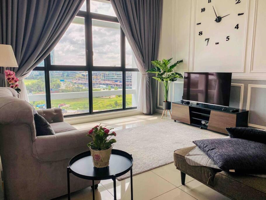 a living room with a couch and a tv at The Icon 1 Condo IOI City Mall Putrajaya, Golf View in Putrajaya