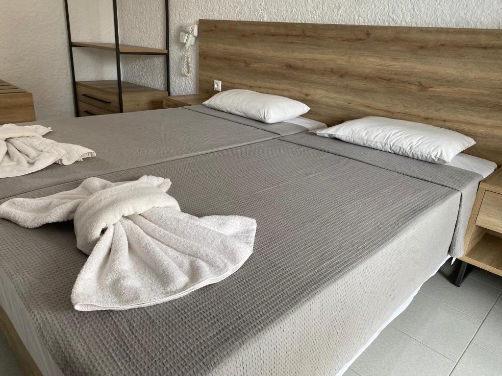 a bedroom with two beds with white towels on them at Georgina in Agia Marina Aegina