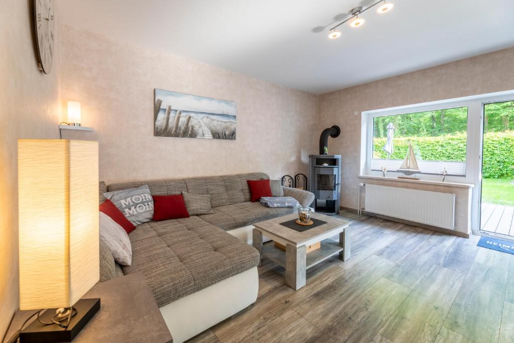 a living room with a couch and a table at Haus Hamburg Wohnung 1 in Hohwacht