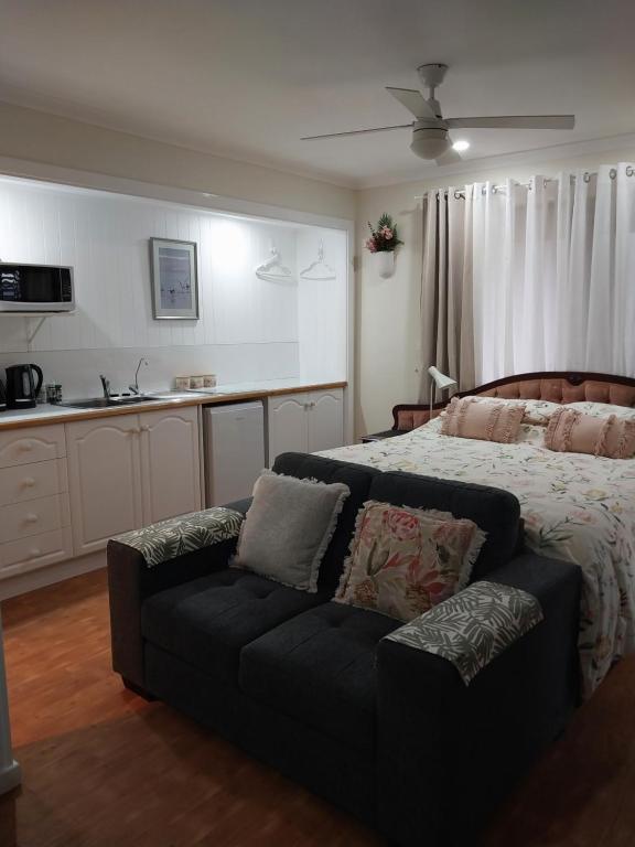 a bedroom with a bed and a couch at The Treasure Box in Esperance