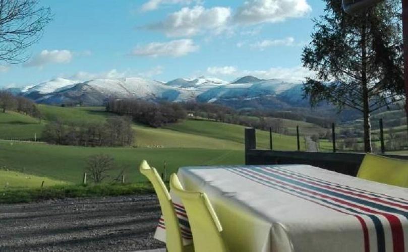 a table and chairs with a view of the mountains at Bidainia in Ainhice-Mongelos