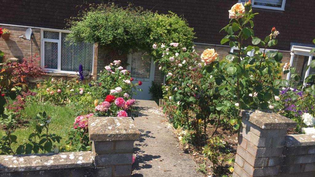 a garden with flowers in front of a house at Captivating 2-Bed House in Amesbury Salisbury in Amesbury