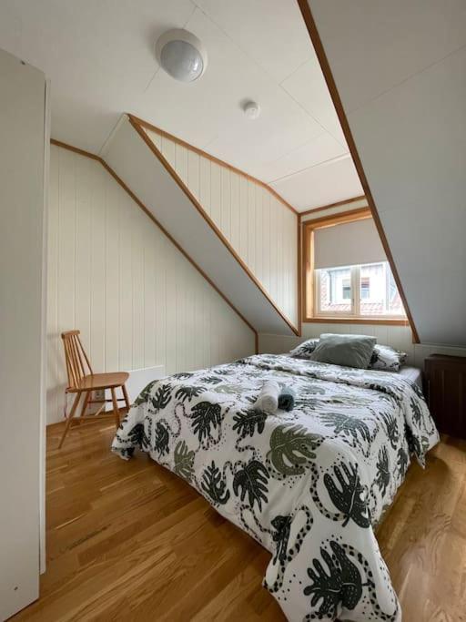 a bedroom with a bed in a attic with a window at City Center Stylish Loft in Trondheim
