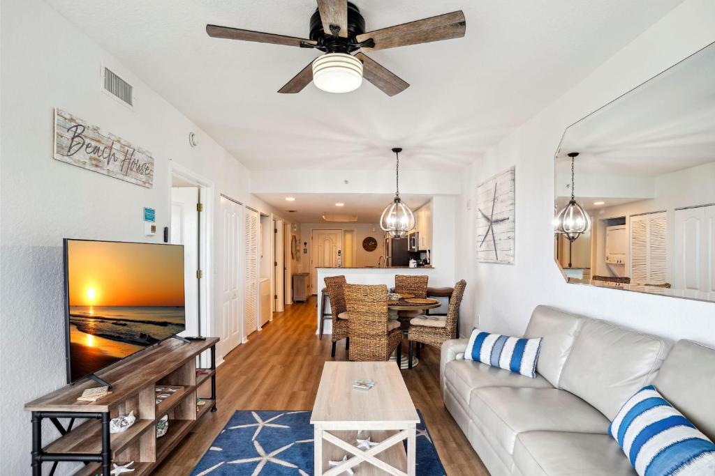 a living room with a couch and a ceiling fan at Sunset Vistas 407S in St Pete Beach