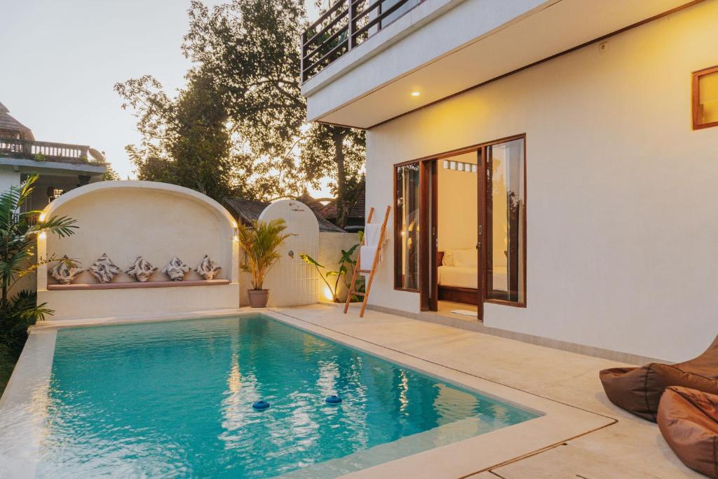 a swimming pool in the backyard of a house at Villa Gading in Ubud