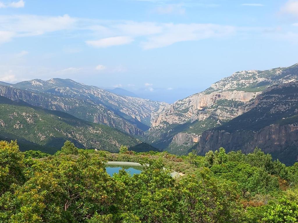 a view of a canyon with a lake in the middle at Glamping tent nel Supramonte in Urzulei