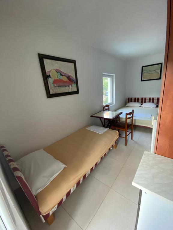 a room with a bed and a table in it at Villa Djekovic in Čanj