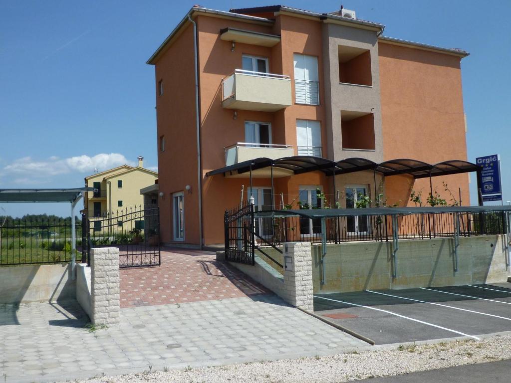 un edificio con un campo da tennis di fronte ad esso di Bed & Breakfast Grgic a Novigrad Istria