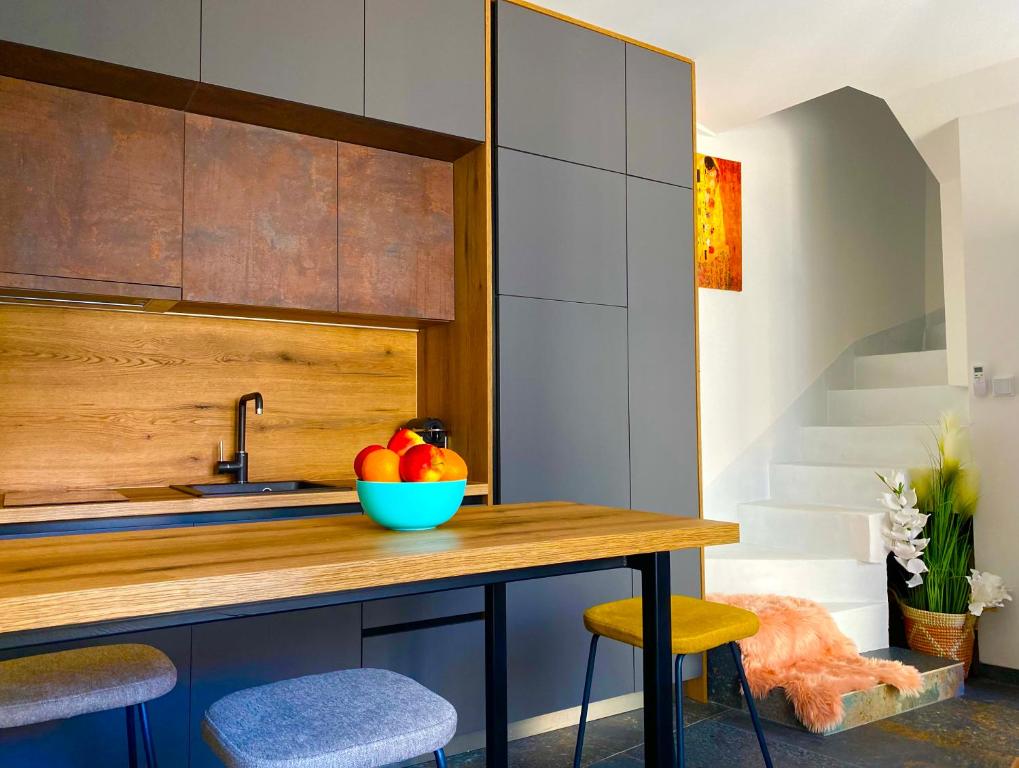 a kitchen with a wooden counter with a bowl of fruit at Kuća za odmor Svelena Vodice in Vodice