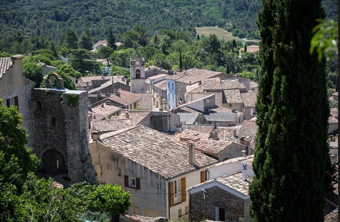 a group of buildings in a village with a church at Le Provence in Gréoux-les-Bains