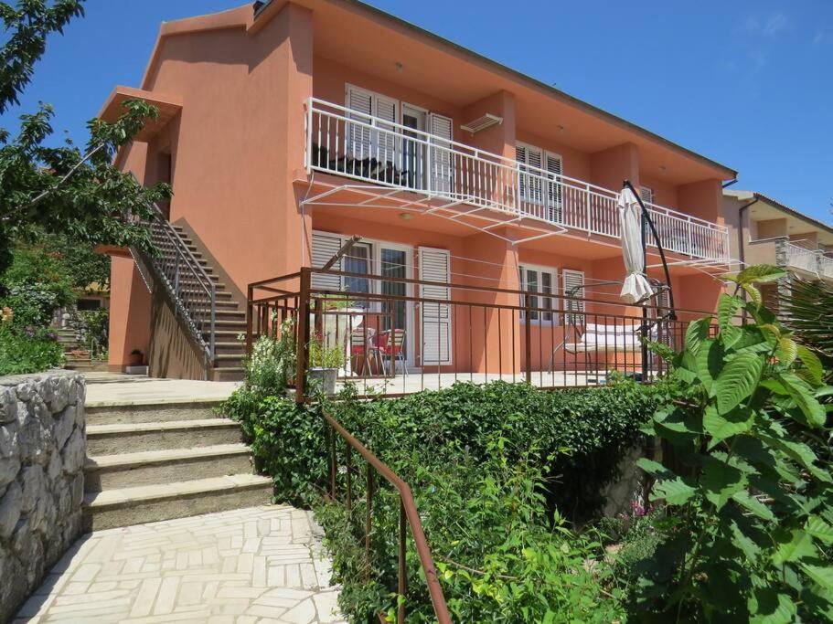a building with a staircase leading to a house at Apartment with 2 terrace in Cres