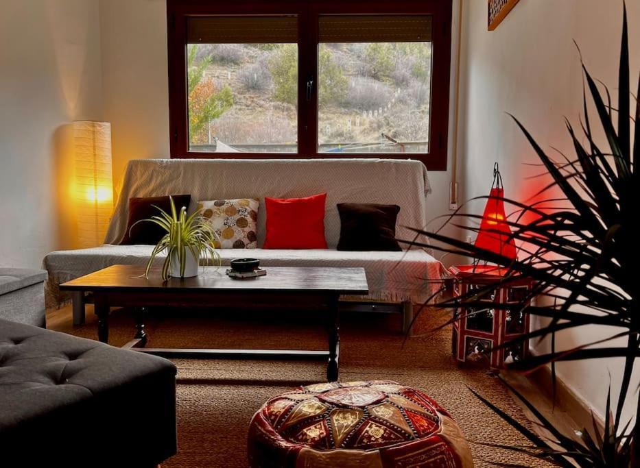 a living room with a couch and a table at Casa rural Hitohouse Bed&Climb in Albarracín