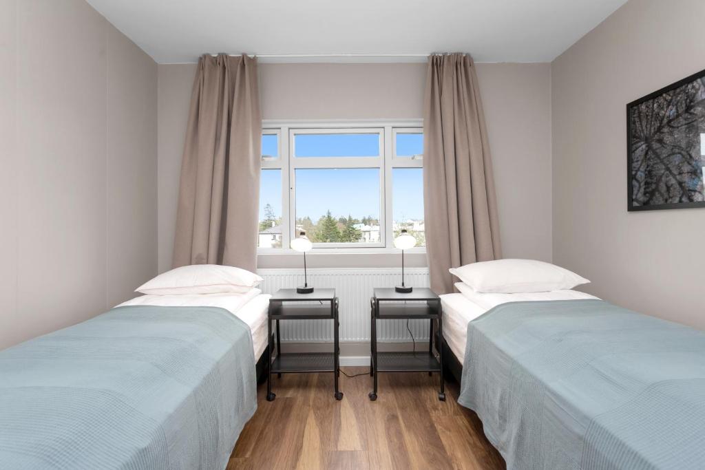 2 camas individuais num quarto com uma janela em Reykjavík Central Guesthouse em Reykjavík