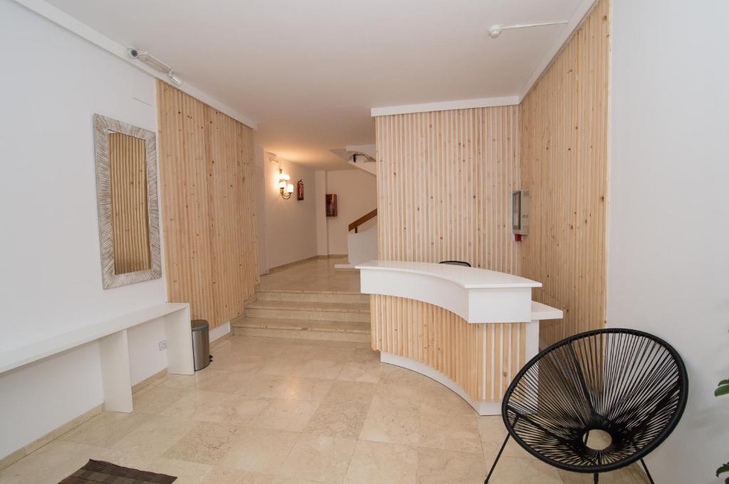 a hallway with wood paneled walls and a staircase at Apartamentos Mestret in San Antonio