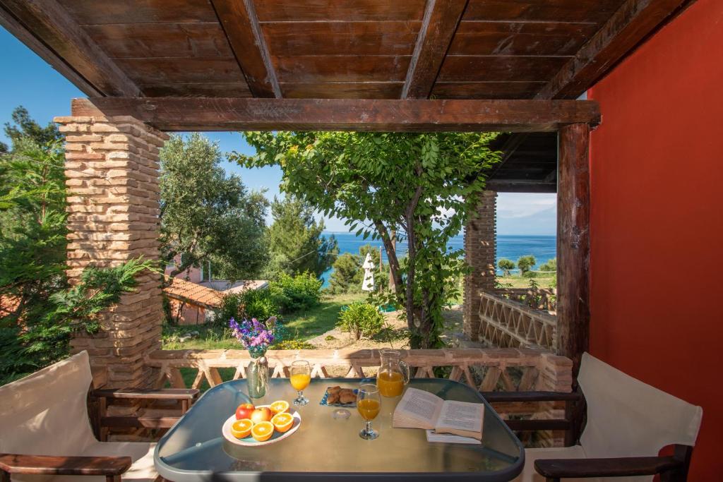 a table in a room with a view of the ocean at Arpyia in Vasilikos