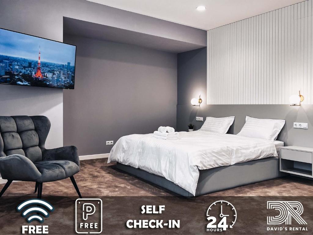 a bedroom with a bed and a chair and a tv at DAVID'S RENTAL ROOMs in Bucharest