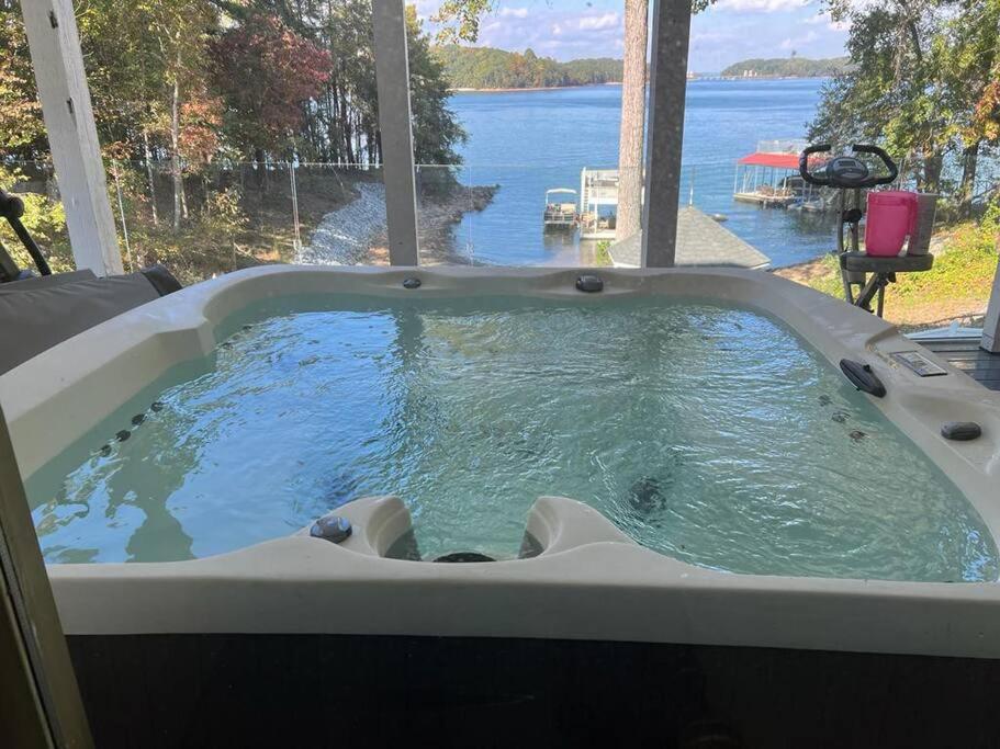 a jacuzzi tub with a view of the water at Luxurious Chalet over Margaritaville in Buford
