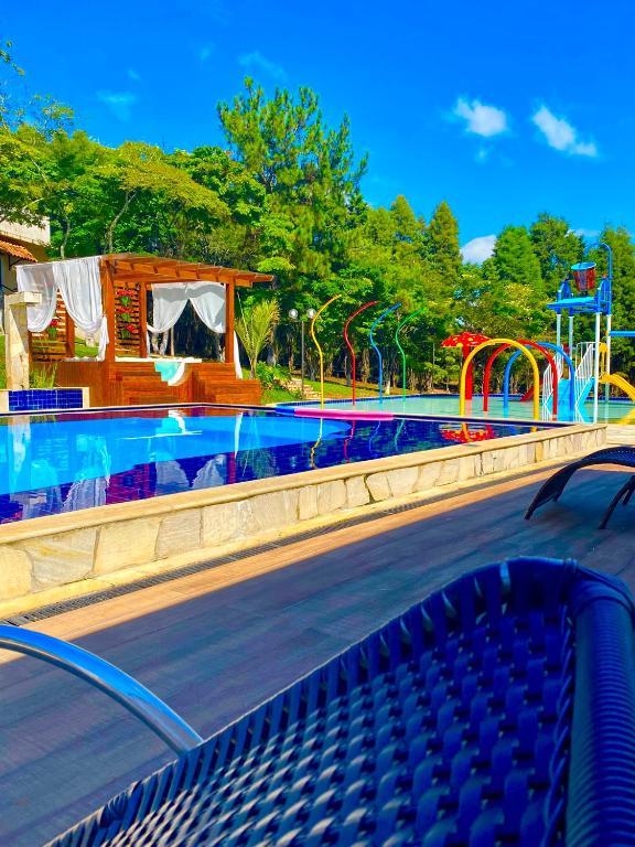 a water park with a pool and a slide at Pousada Valle das Colinas in Tiradentes