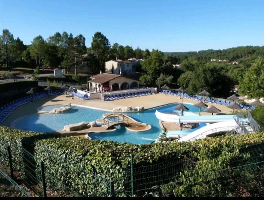 a large swimming pool with slides and boats in it at Les faïsses ardèchoises in Salavas