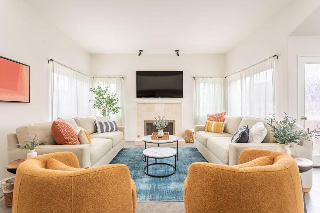 a living room with two couches and a tv at Relax and Unwind Luxe Home Blocks from Beach in Hermosa Beach