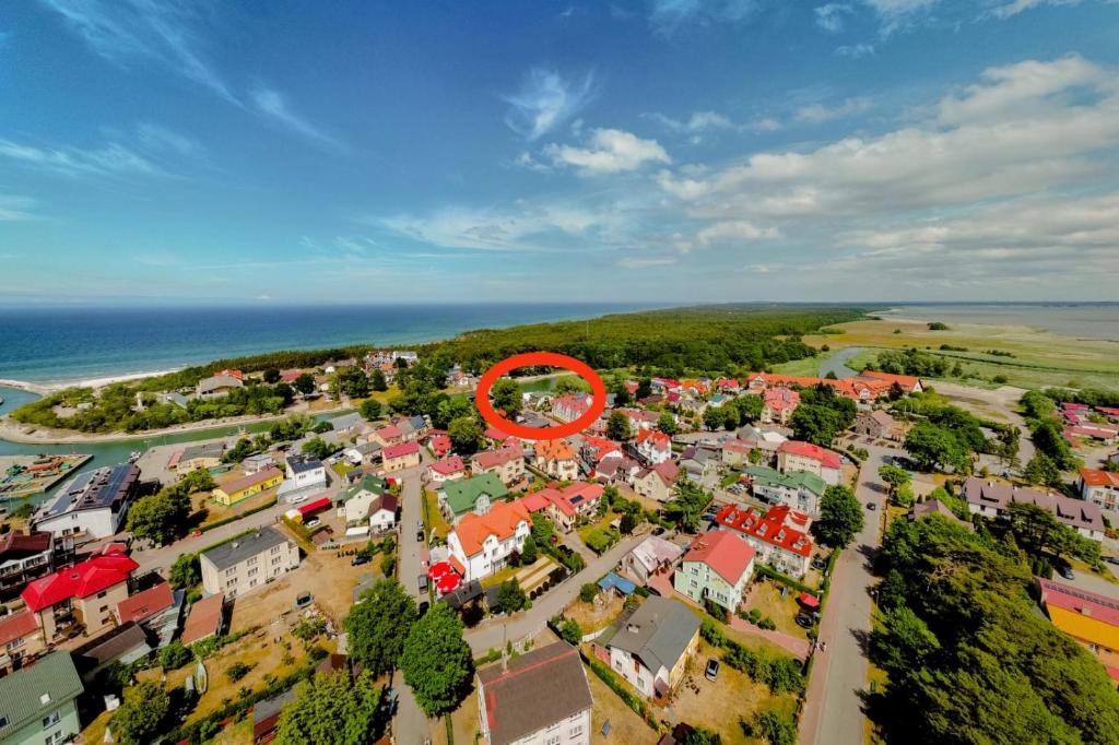 an aerial view of a town with a red circle at Dom, Pokoje, Kwatery Prywatne Przy Rzeźbie Rybaka in Rowy