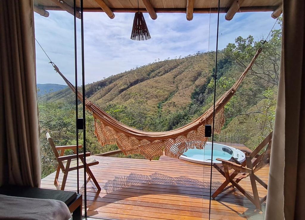 a hammock in a room with a view of a mountain at Rustik in Alto Paraíso de Goiás