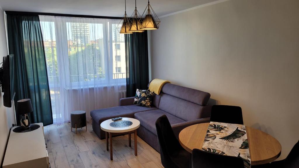 a living room with a couch and a table at Apartament nad morzem in Gdańsk