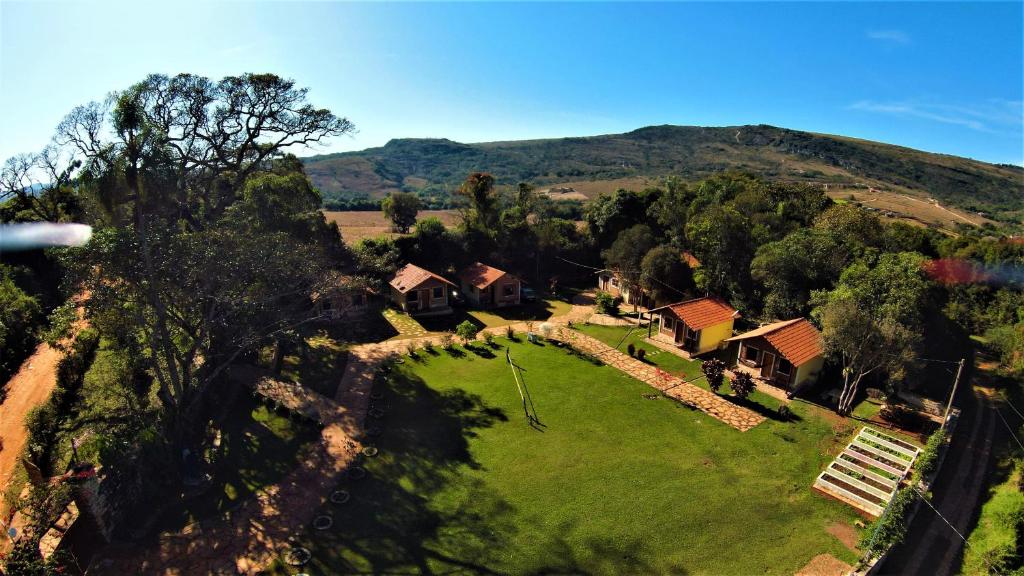 an aerial view of a house on a green field at Pousada Muro de Pedra in São Thomé das Letras