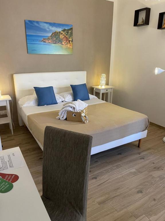 a bedroom with a large bed with blue pillows at B&B La Torre in Realmonte