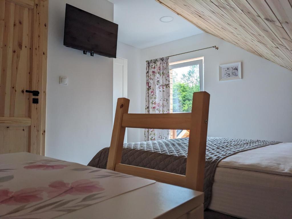 Postel nebo postele na pokoji v ubytování Modrzewiowe Zacisze